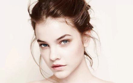 Close-up of Hungarian celebrity Barbara Palvin, showcasing her striking features and blue eyes, designed as an HD desktop wallpaper background.