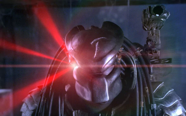 A striking HD desktop wallpaper featuring Scar, the Predator from the movie Alien vs. Predator, showcasing his menacing helmet and glowing laser eyes.