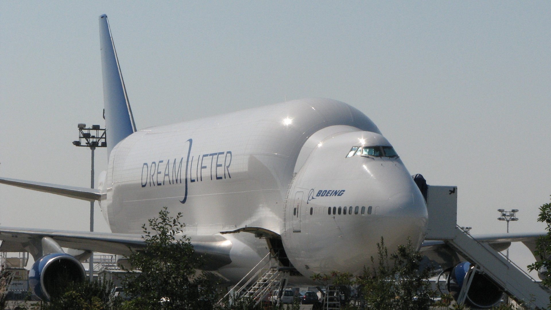 Boeing 747 Dreamlifter cargo aircraft with DREAMLIFTER logo on the tarmac — airplane/vehicle image used as a 2K Quad HD PC desktop wallpaper background.