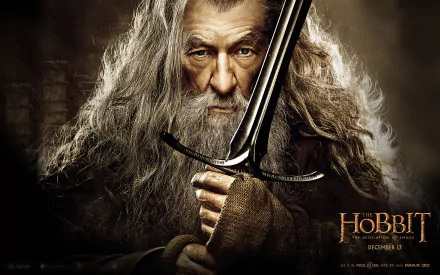 Gandalf from The Hobbit: The Desolation of Smaug, wielding a sword with a determined expression, set against a dark, atmospheric background. HD wallpaper for fans of the film.
