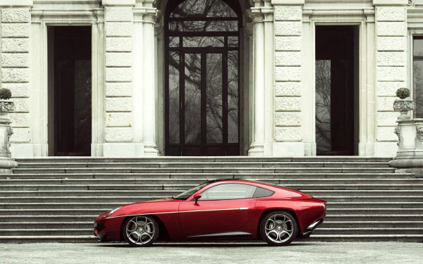 Red Alfa Romeo Disco Volante vehicle parked on stone steps before a classical building — 2K Quad HD PC desktop wallpaper background.