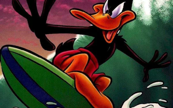 Daffy Duck animated character from the TV show Looney Tunes, joyfully surfing on a vibrant green surfboard against a colorful wave backdrop, featured as an HD desktop wallpaper.