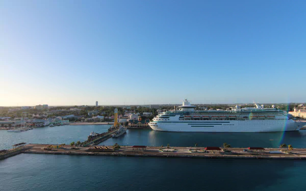 High-resolution 4K Ultra HD image of the Oasis Of The Seas cruise ship docked at a harbor, showcasing a clear blue sky and calm waters as a PC desktop wallpaper.