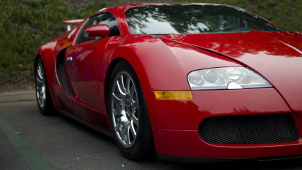 A striking red Bugatti Veyron parked, showcasing its sleek design and powerful stance, making it an impressive element for any HD desktop wallpaper.