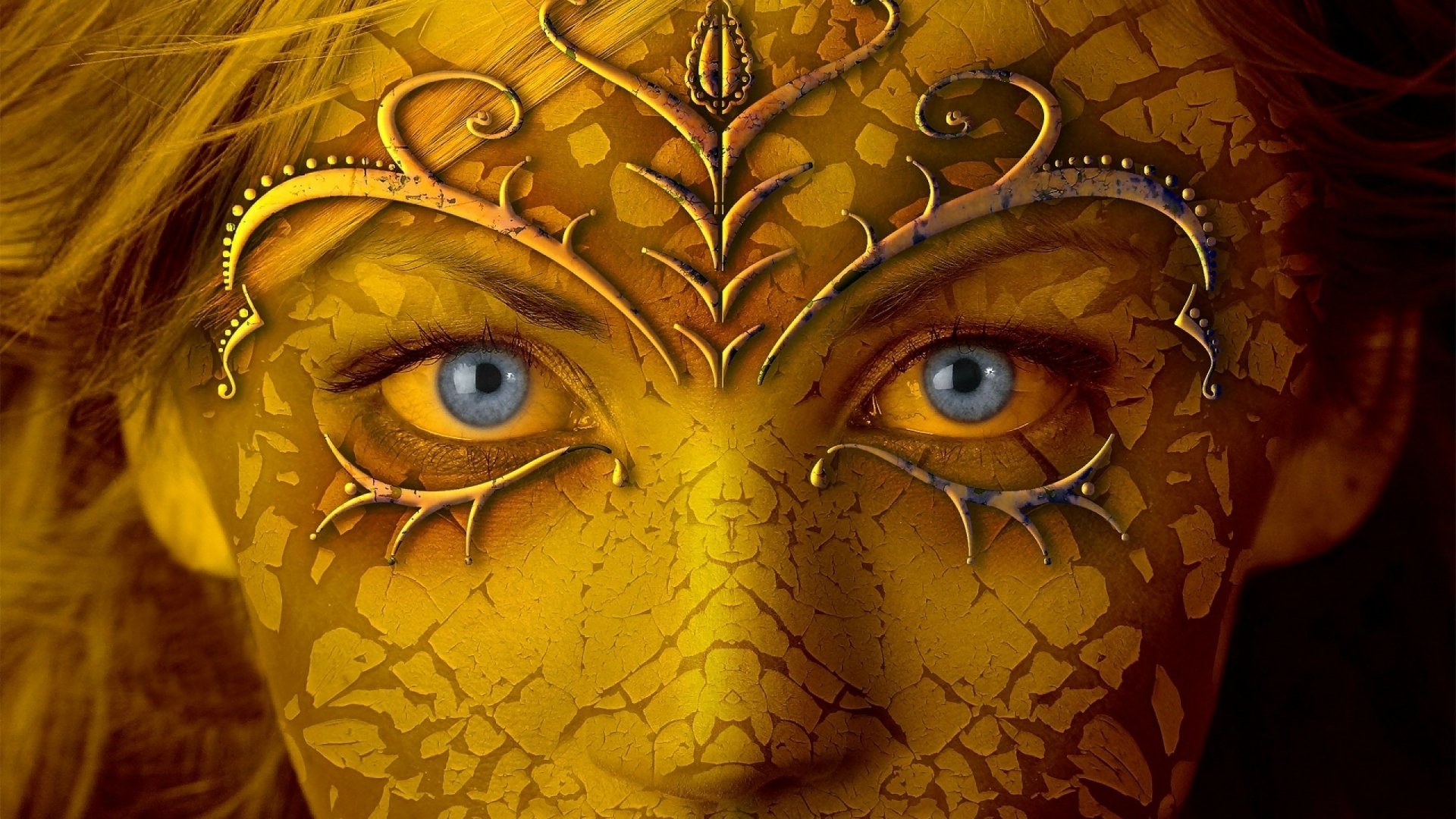 HD desktop wallpaper featuring a fantasy image of a woman with striking blue eyes and golden, ornate face paint in intricate leaf and swirl designs.