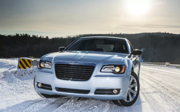 Chrysler 300 Glacier vehicle in silver on a snow-covered road at sunrise, frontal three-quarter view — HD PC desktop wallpaper and background.