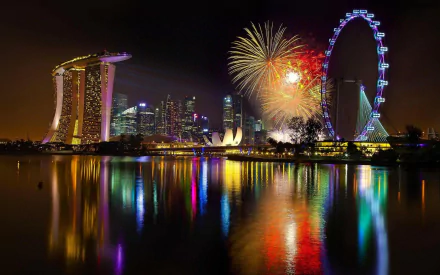 A vibrant night scene of Singapore featuring Marina Bay Sands and the Singapore Flyer, illuminated by dazzling fireworks and colorful reflections on the water.
