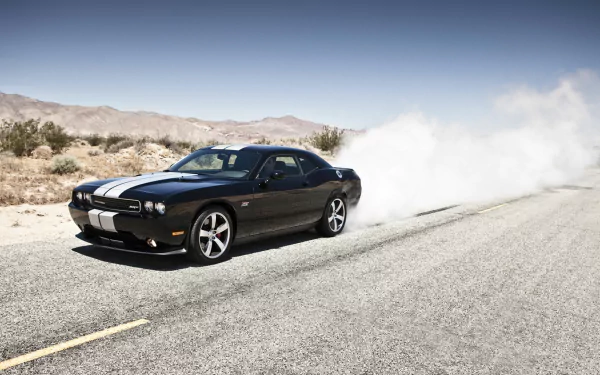 Black Dodge Dodge Challenger SRT8 392 burning out on a desert road, leaving a plume of smoke — HD PC desktop wallpaper and background