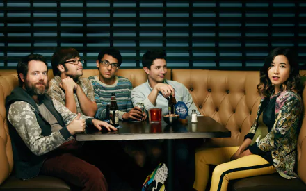 HD desktop wallpaper featuring a stylish group of people in a modern bar setting, tagged with Betas.