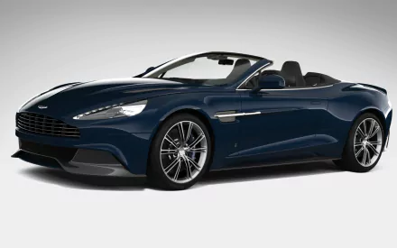 HD PC desktop wallpaper featuring a sleek dark blue Aston Martin Vanquish Volante convertible sports car against a plain background.