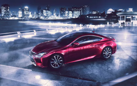 Red Lexus RC coupe parked on a wet waterfront at night with an illuminated city skyline — 2K Quad HD PC desktop wallpaper and background featuring the Lexus vehicle.