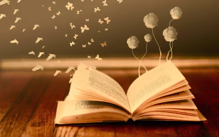An enchanting HD desktop wallpaper featuring an open fantasy book with butterflies and flowers emerging from its pages, set on a wooden surface.