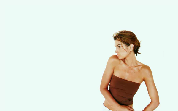 HD desktop wallpaper featuring celebrity Cindy Crawford posing against a plain, light background.