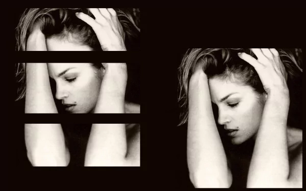 HD desktop wallpaper featuring a black-and-white artistic portrait of celebrity Cindy Crawford with her hands in her hair against a dark background.