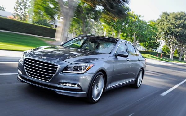 A sleek silver Hyundai Genesis sedan in motion on a tree-lined street, captured in HD for a dynamic PC desktop wallpaper and background.