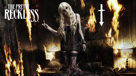 HD desktop wallpaper featuring a fiery scene with a woman in gothic attire, embodying the dark, edgy vibe of The Pretty Reckless and their Reckless theme.