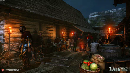 HD PC desktop wallpaper/background from the video game Kingdom Come: Deliverance — a torchlit medieval village market at night with armored figures and townsfolk.