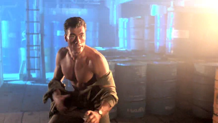 Shirtless action hero crouches in a dim industrial warehouse amid stacked barrels, blue backlighting and lens flare — HD PC desktop wallpaper/background from the movie Double Impact.