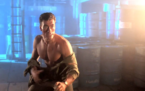 Shirtless action hero crouches in a dim industrial warehouse amid stacked barrels, blue backlighting and lens flare — HD PC desktop wallpaper/background from the movie Double Impact.