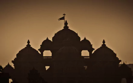 Silhouette of the Akshardham temple against a golden sky, captured as a HD PC desktop wallpaper reflecting its religious and architectural grandeur.