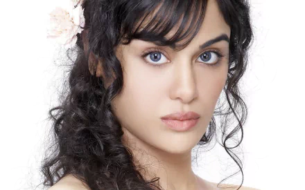 HD wallpaper featuring celebrity Adah Sharma, showcasing her striking beauty with flowing hair and captivating eyes, set against a clean white background.