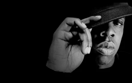 Black-and-white HD desktop wallpaper featuring a close-up of Jay-Z wearing a hat, with a dark background emphasizing his music icon presence.
