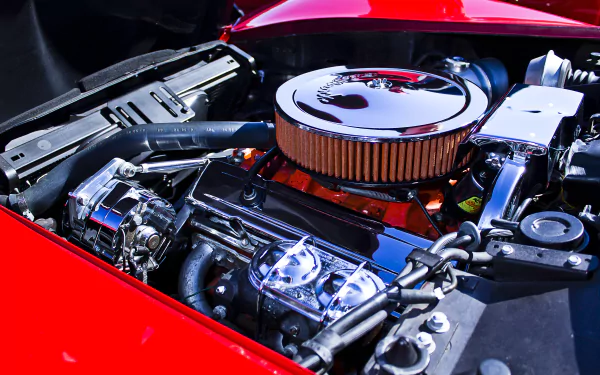 4K Ultra HD PC desktop wallpaper: close-up of a Chevrolet Corvette Stingray vehicle's engine bay, polished chrome air filter and components against glossy red bodywork.