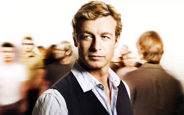 HD PC desktop wallpaper featuring Simon Baker as Patrick Jane from the TV show The Mentalist, with blurred figures in the background.