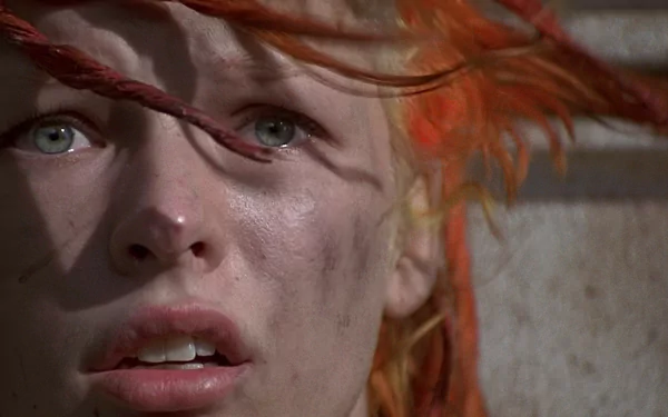 Close-up HD desktop wallpaper of Leeloo, portrayed by Milla Jovovich in the movie The Fifth Element, featuring her striking red hair and intense expression.