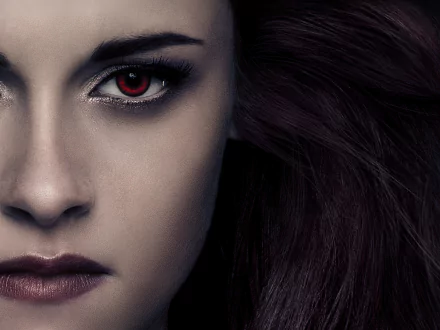 Close-up of Bella Swan, portrayed by Kristen Stewart, from The Twilight Saga: Breaking Dawn - Part 2, featuring striking red eyes and dark hair in a dramatic HD wallpaper.