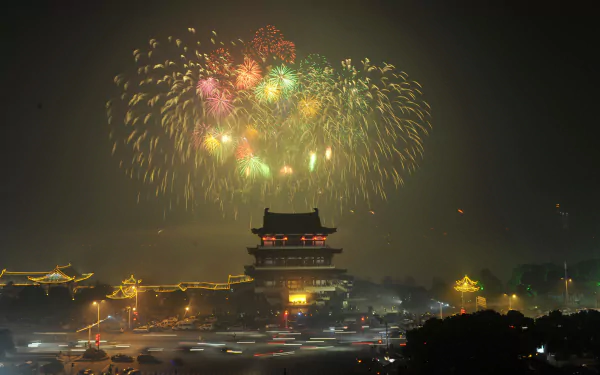Man-made Changsha nightscape with fireworks above an illuminated traditional tower, 2K Quad HD PC desktop wallpaper/background.