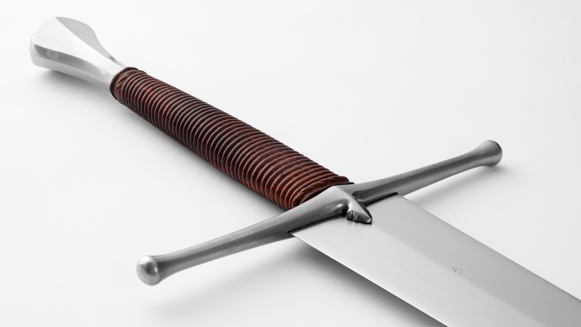HD PC desktop wallpaper featuring a close-up of a man-made sword with a detailed leather-wrapped handle and gleaming crossguard on a white background.