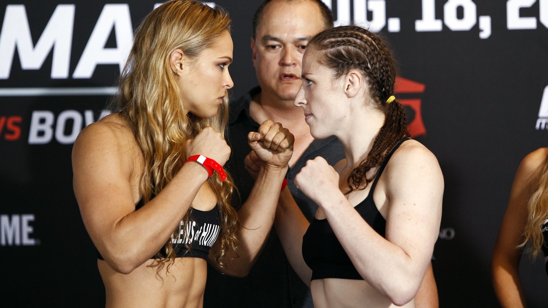 HD PC desktop wallpaper featuring Ronda Rousey and an opponent facing off during a sports event weigh-in.