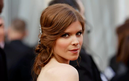 HD desktop wallpaper featuring American actress and celebrity Kate Mara, captured in a close-up portrait with elegant hairstyle and soft expression.