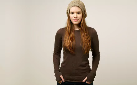 Portrait of American actress Kate Mara in a casual brown long-sleeve top and knit hat, captured in high-resolution 4K Ultra HD for a PC desktop wallpaper.