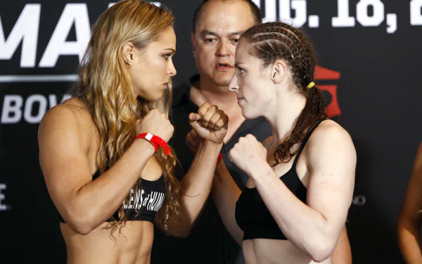 HD PC desktop wallpaper featuring Ronda Rousey and an opponent facing off during a sports event weigh-in.
