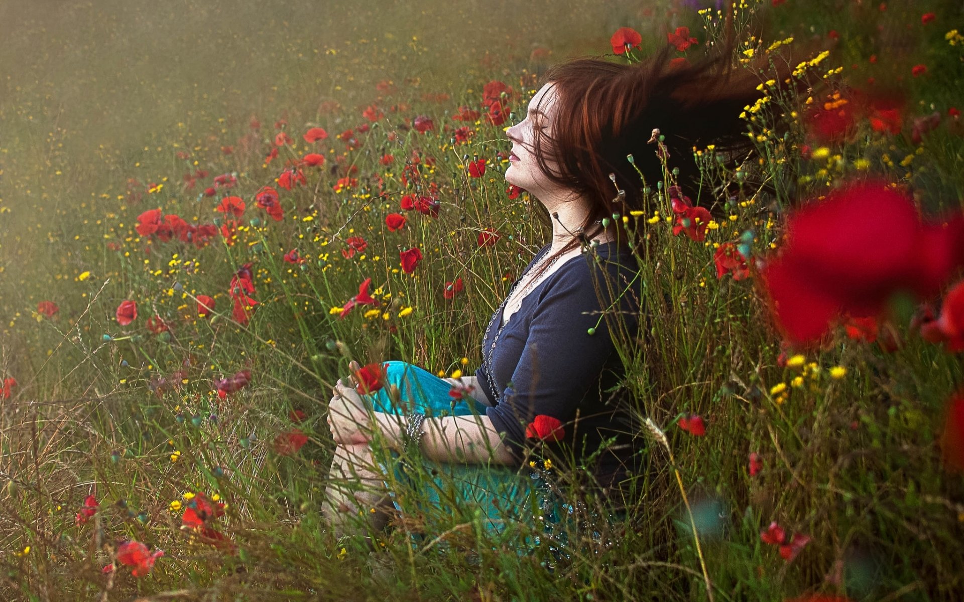 HD desktop wallpaper featuring a woman enjoying a serene moment in a vibrant meadow filled with wildflowers, capturing a tranquil mood.