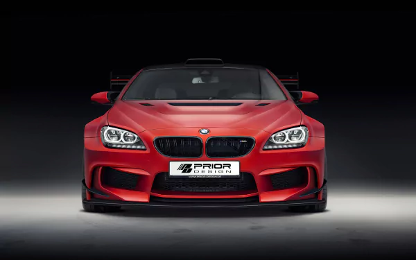 Front view of a red Prior Design BMW M6 showcased in an HD PC desktop wallpaper with a dark background highlighting the vehicle’s aggressive design.