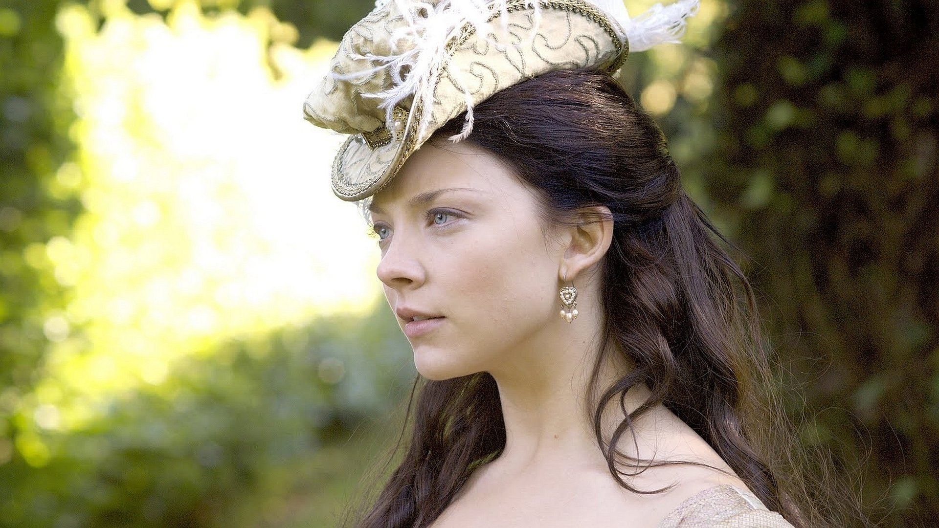 HD desktop wallpaper featuring Natalie Dormer in a period costume from The Tudors, with a detailed white hat and soft natural background.