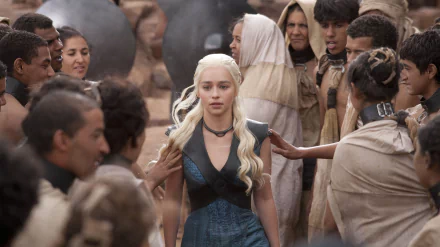Emilia Clarke as Daenerys Targaryen, surrounded by a crowd, in a scene from Game of Thrones. A striking 4K Ultra HD wallpaper showcasing the dynamic atmosphere of the series.