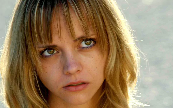 Close-up HD desktop wallpaper of Christina Ricci from the movie Black Snake Moan, featuring her thoughtful expression and soft blonde hair in natural light.