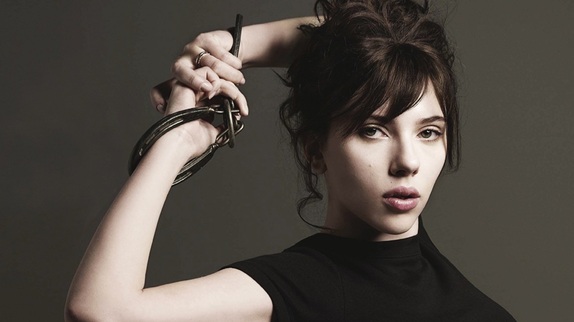 Scarlett Johansson poses confidently in a striking HD desktop wallpaper, showcasing her bold style and captivating expression. A captivating addition to any background.