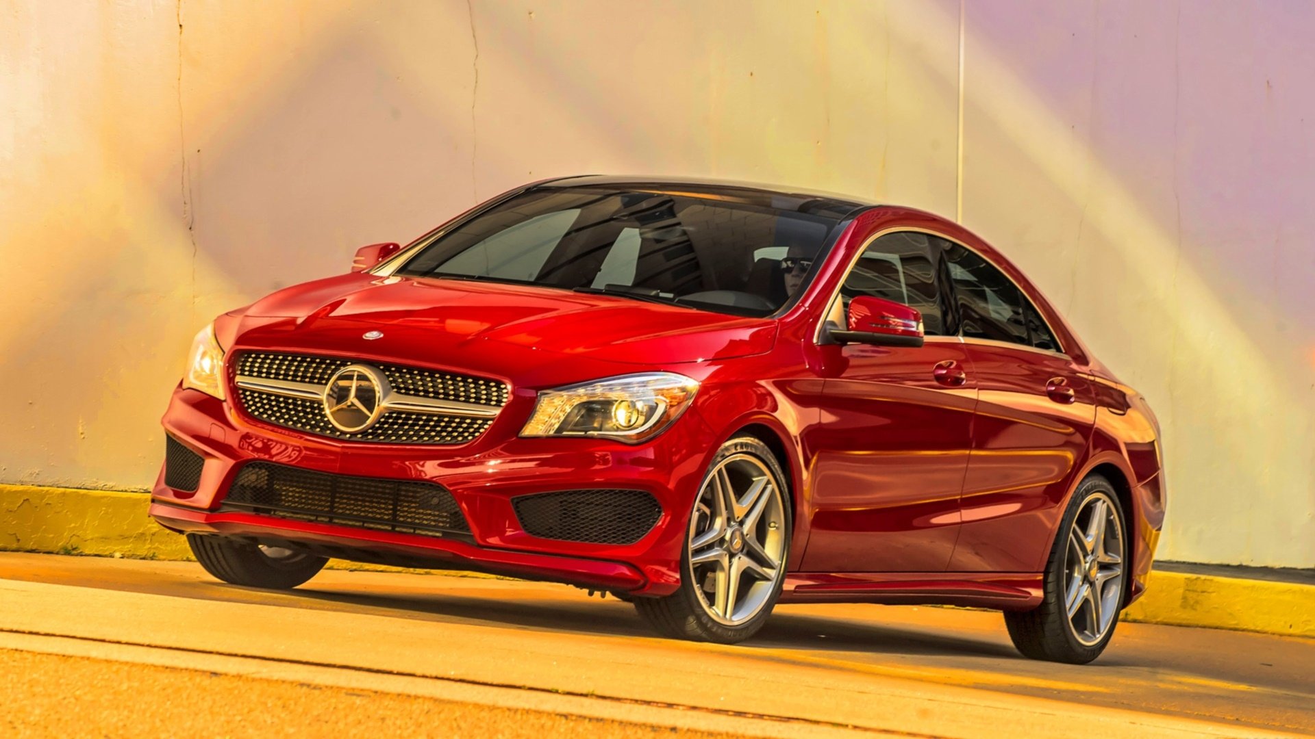 Red Mercedes-Benz CLA-Class vehicle, three-quarter front view on a warm gradient backdrop — HD PC desktop wallpaper/background