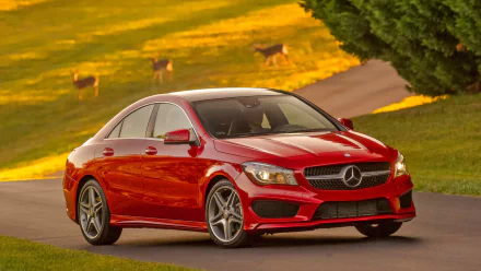 Red Mercedes-Benz CLA-Class vehicle on a winding country road at golden hour — HD PC desktop wallpaper background.