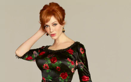 HD desktop wallpaper of American actress and celebrity Christina Hendricks wearing a black floral dress with red roses against a plain background.