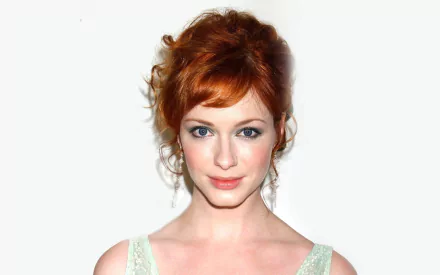 HD desktop wallpaper featuring American actress and celebrity Christina Hendricks with red hair styled up against a plain white background.