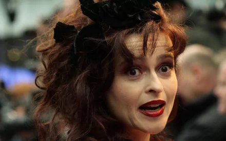 HD PC desktop wallpaper featuring English actress Helena Bonham Carter with expressive makeup and styled hair in a candid celebrity moment.