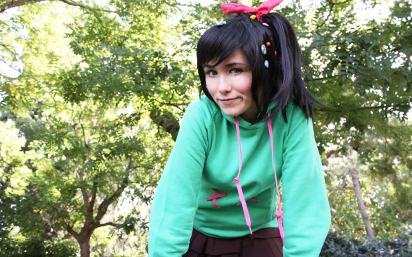 A woman cosplaying Vanellope von Schweetz from Wreck-It Ralph poses outdoors in a 4K Ultra HD PC desktop wallpaper background.