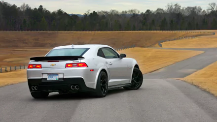 White Chevrolet Camaro Z28 driving on a winding road, captured in sharp detail as an HD PC desktop wallpaper and background.