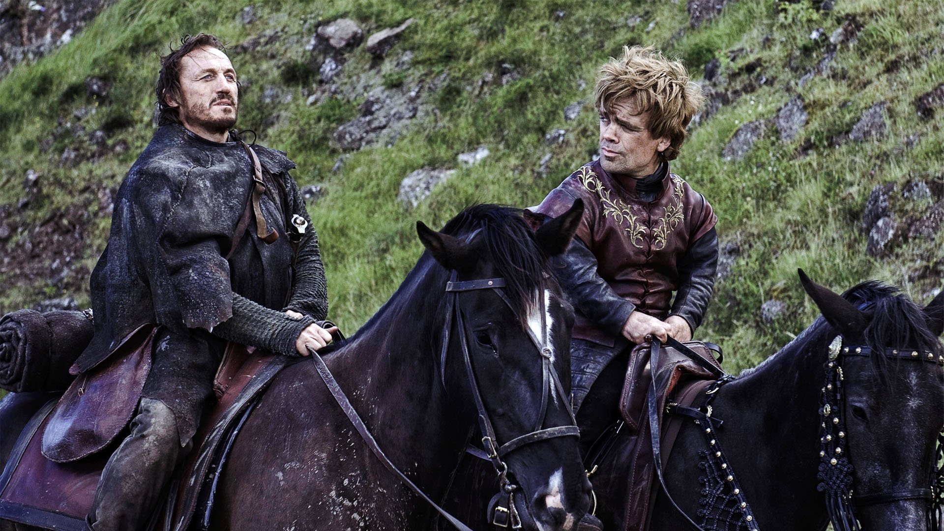 HD desktop wallpaper featuring Jerome Flynn as Bronn and Peter Dinklage as Tyrion Lannister from the TV show Game of Thrones, both on horseback in a grassy landscape.